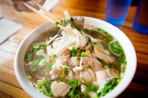 (bowl of beef pho) Vietnamese Pho Noodle Soup with variety of meat and vegetables.